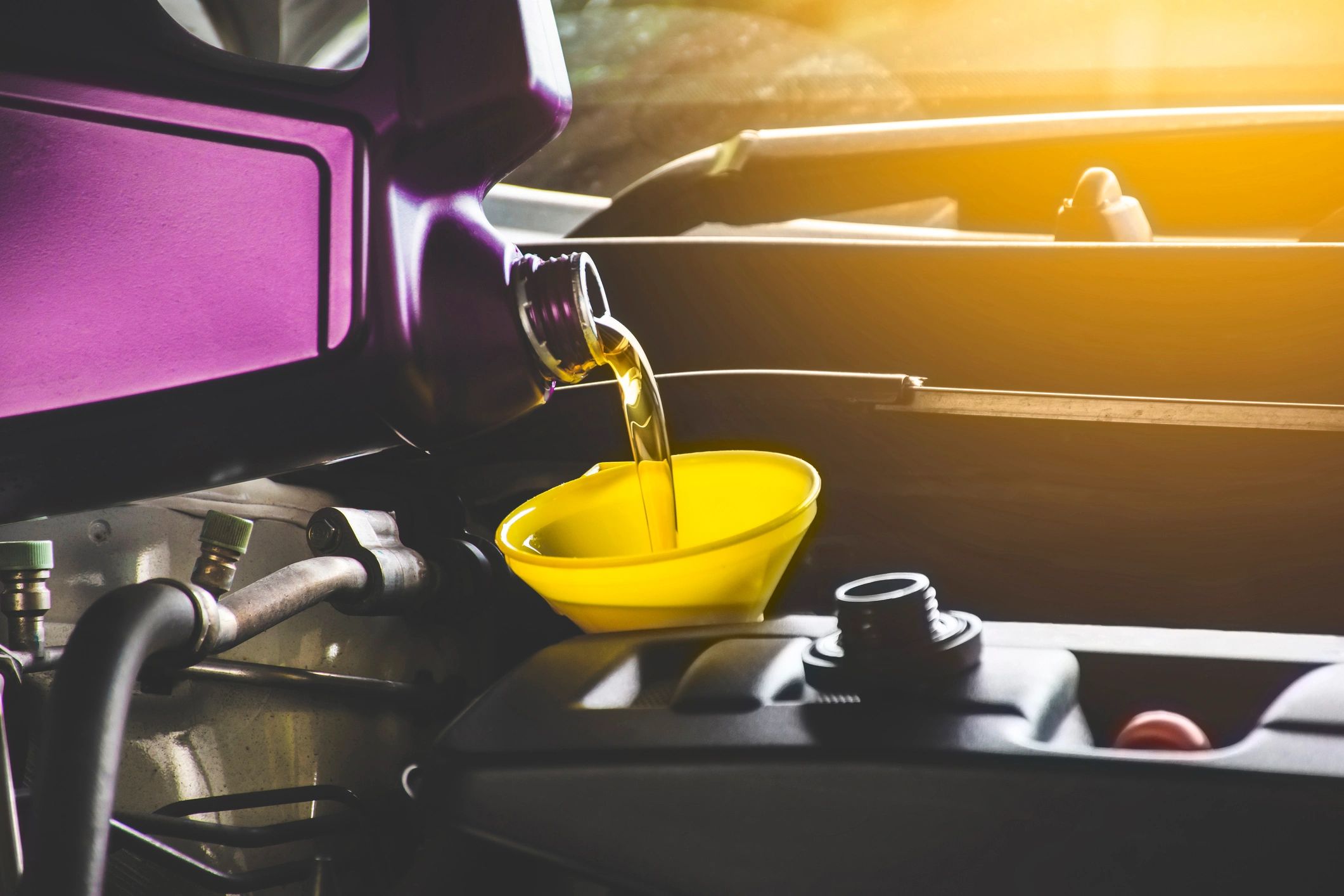 Mechanic pouring engine oil
